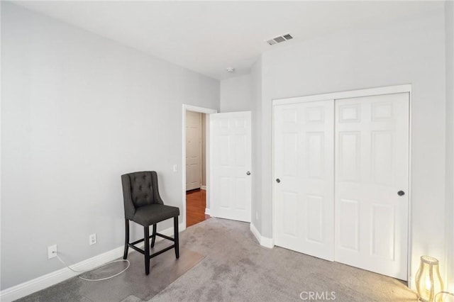 living area featuring visible vents, baseboards, and carpet flooring