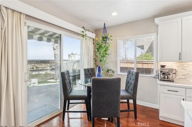 dining space with recessed lighting, baseboards, and dark wood-type flooring