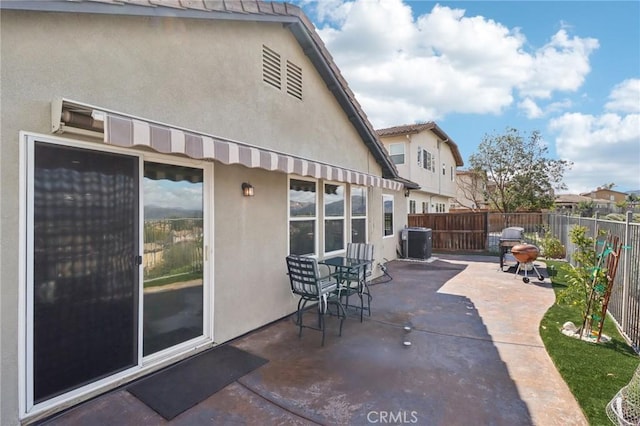 view of patio featuring central air condition unit and a fenced backyard