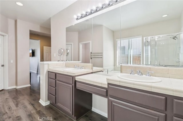 full bath featuring baseboards, recessed lighting, a stall shower, wood finished floors, and vanity