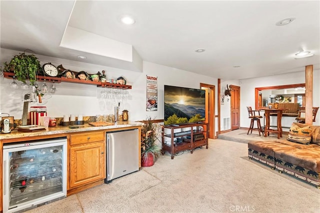 bar featuring recessed lighting, beverage cooler, light colored carpet, freestanding refrigerator, and indoor wet bar