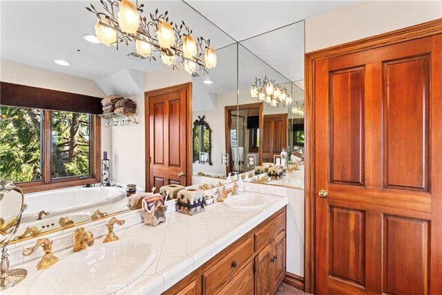 145 Pheasant Run, Lake Arrowhead, CA 92352 - bathroom featuring a chandelier, double vanity, a bath, and recessed lighting