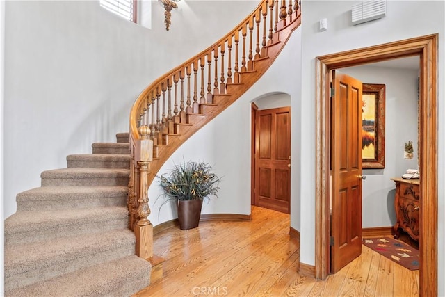 145 Pheasant Run, Lake Arrowhead, CA 92352 - stairs with wood-type flooring and a towering ceiling