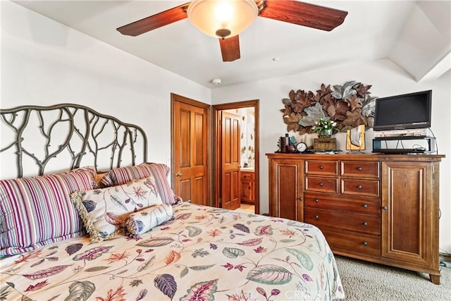 bedroom featuring lofted ceiling, a ceiling fan, and light colored carpet