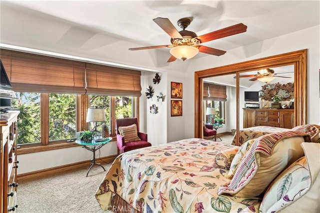 carpeted bedroom with access to outside, ceiling fan, and baseboards