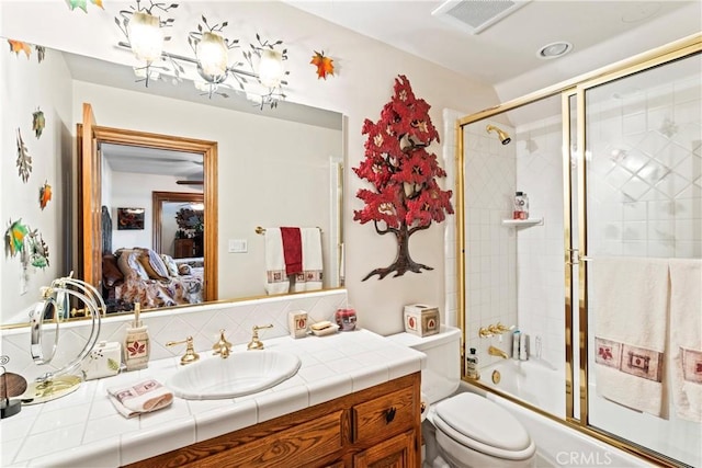 ensuite bathroom featuring visible vents, toilet, ensuite bath, enclosed tub / shower combo, and vanity