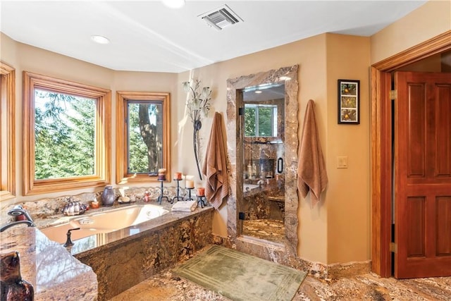 bathroom with a bath, a stall shower, and visible vents