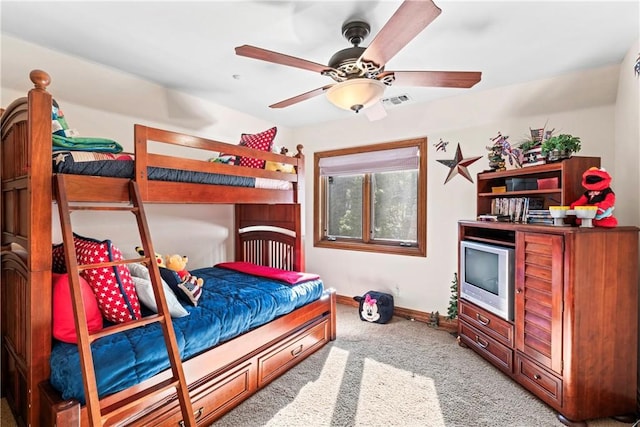 carpeted bedroom with visible vents, ceiling fan, and baseboards