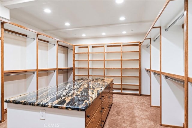 spacious closet featuring light colored carpet