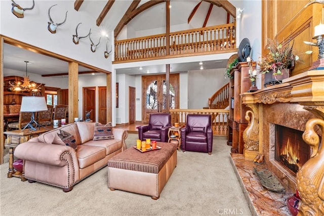 145 Pheasant Run, Lake Arrowhead, CA 92352 - carpeted living room with a fireplace, a high ceiling, a chandelier, and stairway