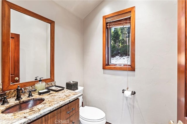 half bath with vanity and toilet