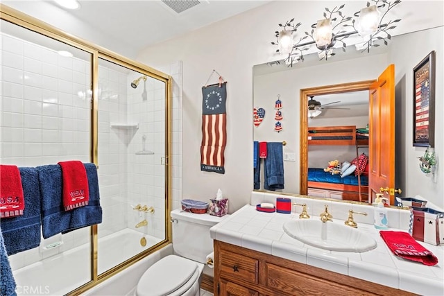 full bath with visible vents, shower / bath combination with glass door, vanity, and toilet