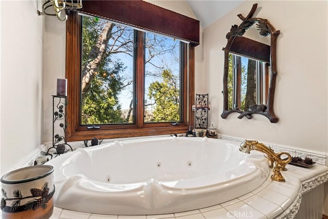 bathroom with lofted ceiling and a whirlpool tub