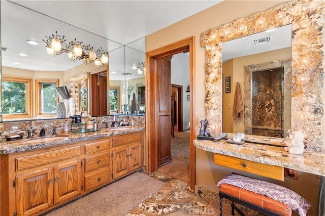 bathroom featuring visible vents, a sink, and double vanity