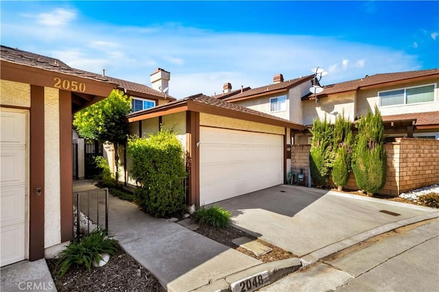 view of front facade featuring stucco siding, a garage, and concrete driveway