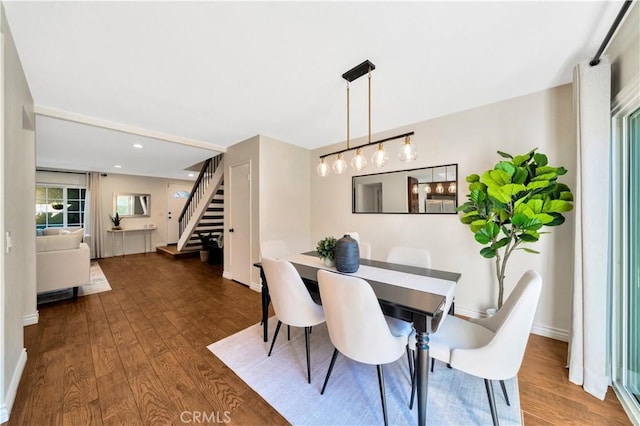 dining area featuring recessed lighting, stairway, baseboards, and wood finished floors