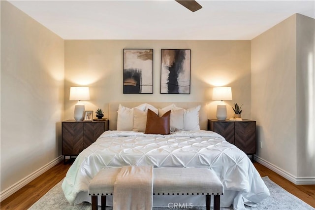 bedroom featuring baseboards and wood finished floors