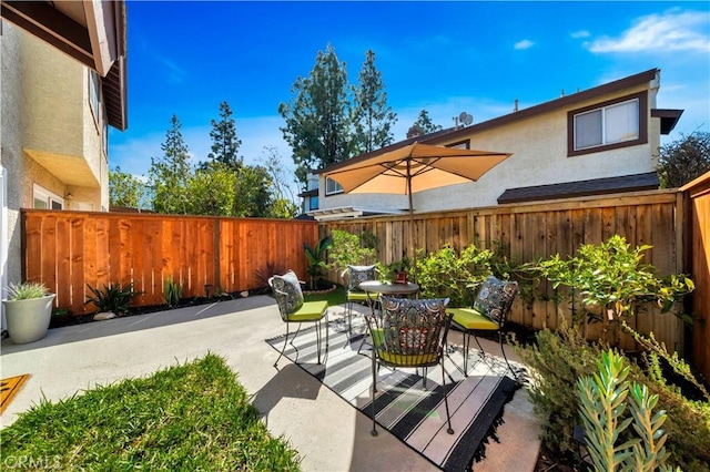 view of patio / terrace featuring outdoor dining area and a fenced backyard