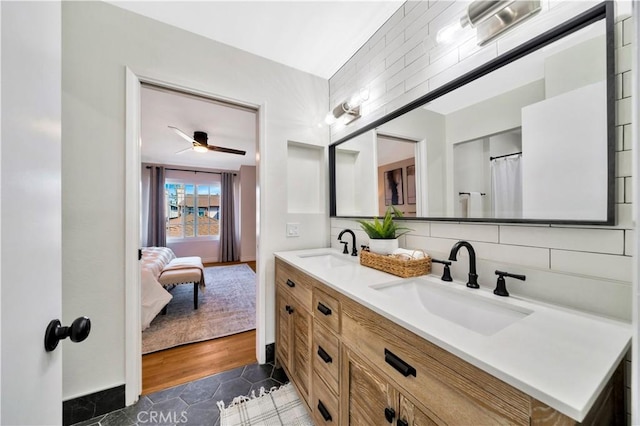 ensuite bathroom with tasteful backsplash, double vanity, ensuite bath, and a sink