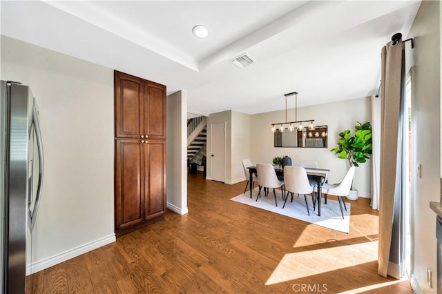 dining area with visible vents, baseboards, a chandelier, stairway, and dark wood-style floors