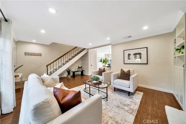 living room featuring recessed lighting, stairs, baseboards, and wood finished floors