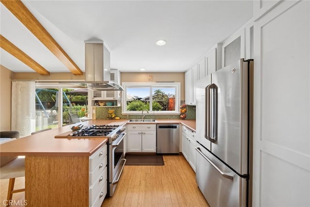 kitchen featuring tasteful backsplash, appliances with stainless steel finishes, white cabinets, and a sink