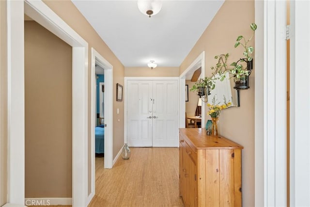 interior space with light wood-type flooring and baseboards