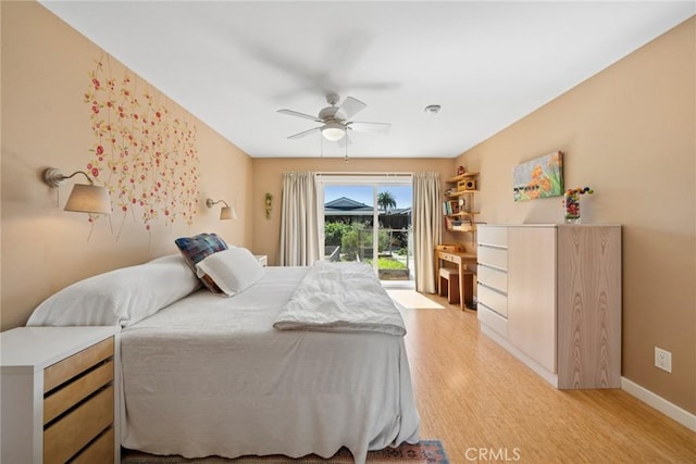 bedroom featuring baseboards, access to outside, a ceiling fan, and light wood-style floors