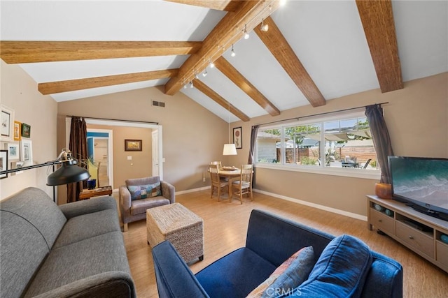 living area with visible vents, lofted ceiling with beams, track lighting, wood finished floors, and baseboards