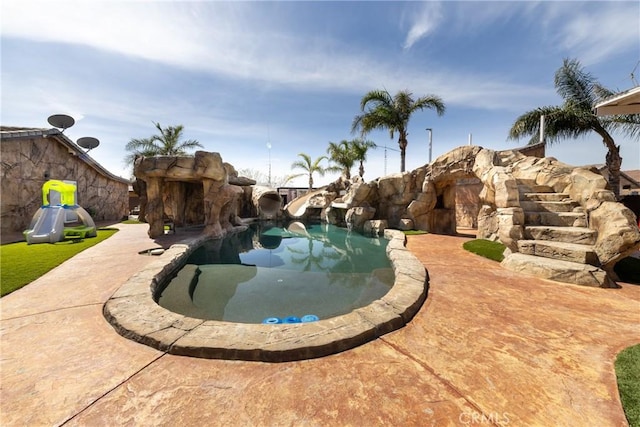 view of swimming pool with a water slide