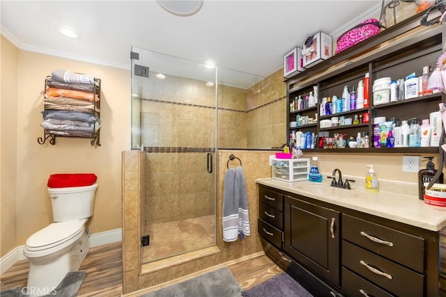 bathroom featuring baseboards, toilet, a shower stall, and vanity
