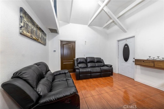 living area featuring visible vents, baseboards, and wood finished floors