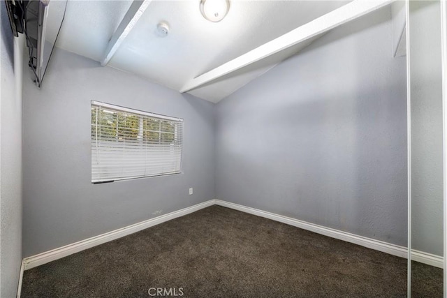 spare room featuring vaulted ceiling, baseboards, and carpet floors