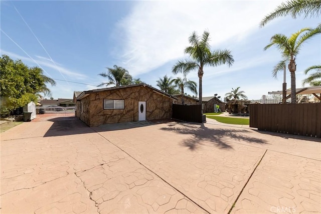 exterior space featuring driveway and fence