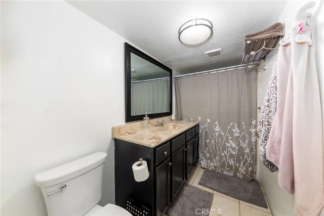 bathroom with vanity, tile patterned floors, toilet, and visible vents