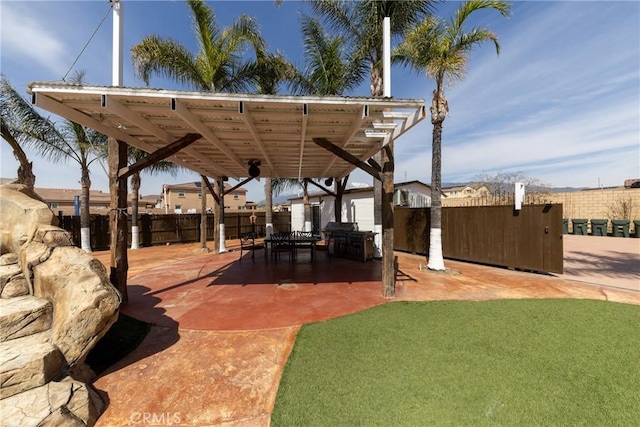 view of patio featuring area for grilling and fence