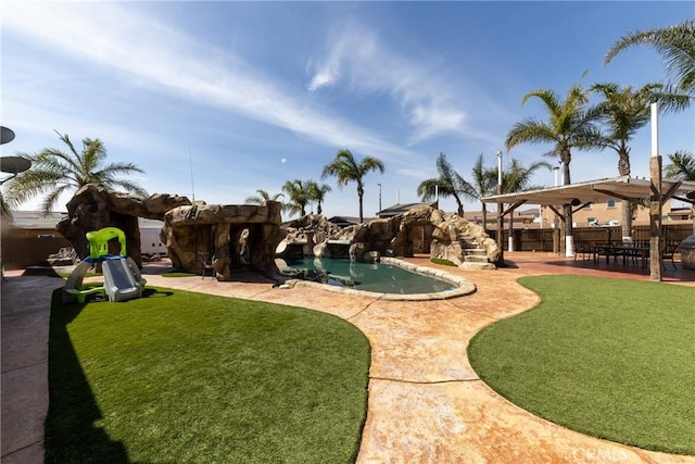 view of yard with a patio area and a fenced in pool