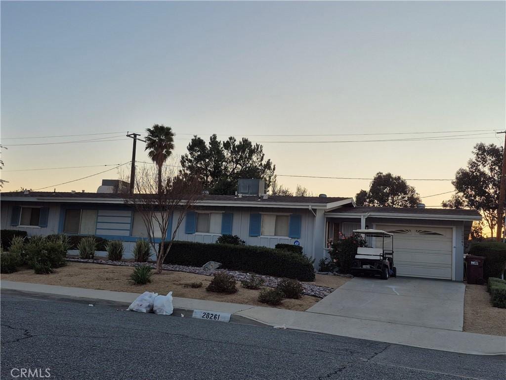 single story home with an attached garage and concrete driveway