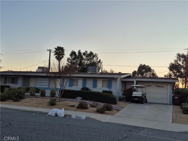 single story home with an attached garage and concrete driveway