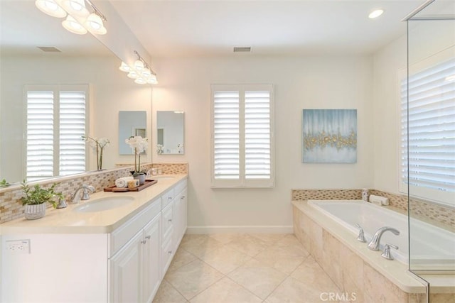 bathroom featuring a bath, visible vents, a sink, and a wealth of natural light