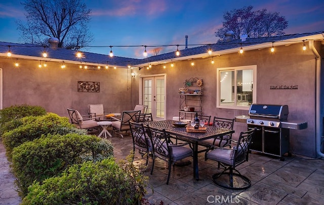 view of patio with outdoor dining space, grilling area, and french doors