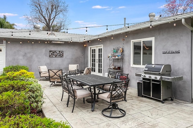 view of patio with french doors, area for grilling, and outdoor dining space