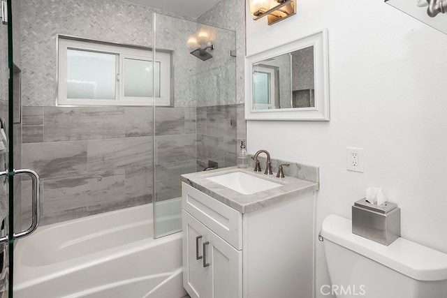 full bath with combined bath / shower with glass door, vanity, and toilet