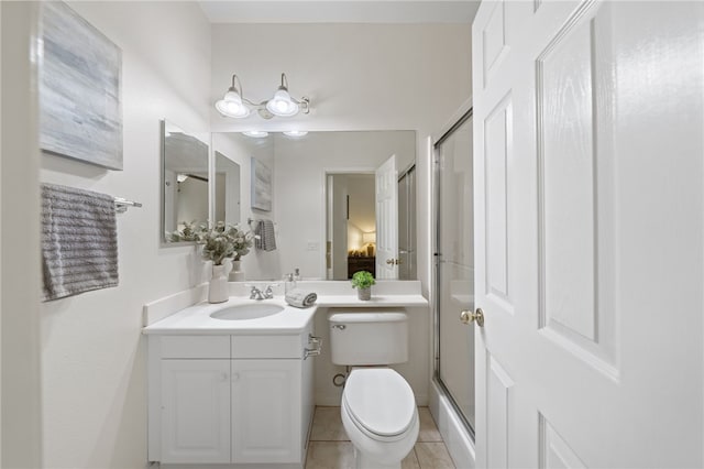 bathroom featuring tile patterned flooring, a shower stall, toilet, and vanity