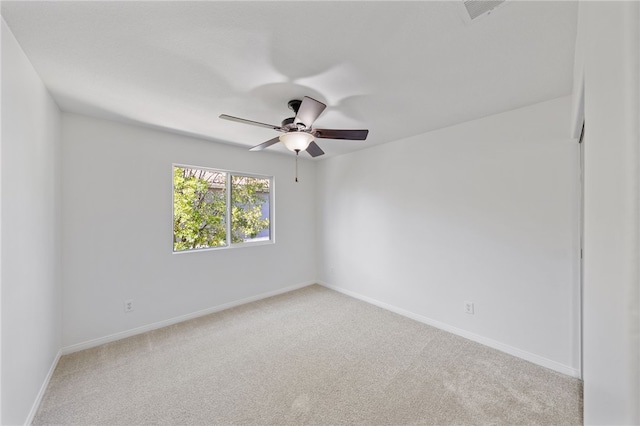 spare room with carpet, visible vents, ceiling fan, and baseboards