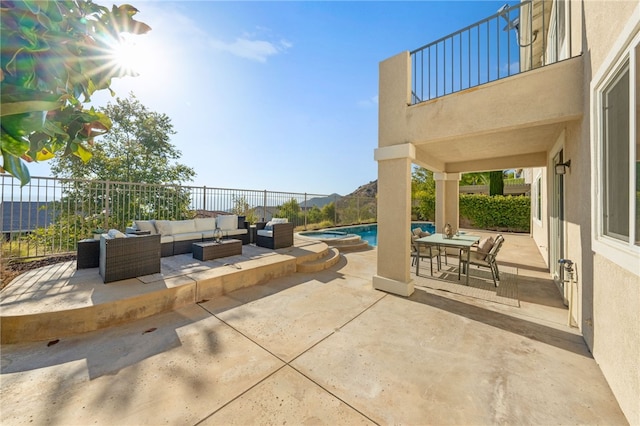 view of patio with outdoor dining area, a fenced backyard, a balcony, an outdoor hangout area, and a fenced in pool