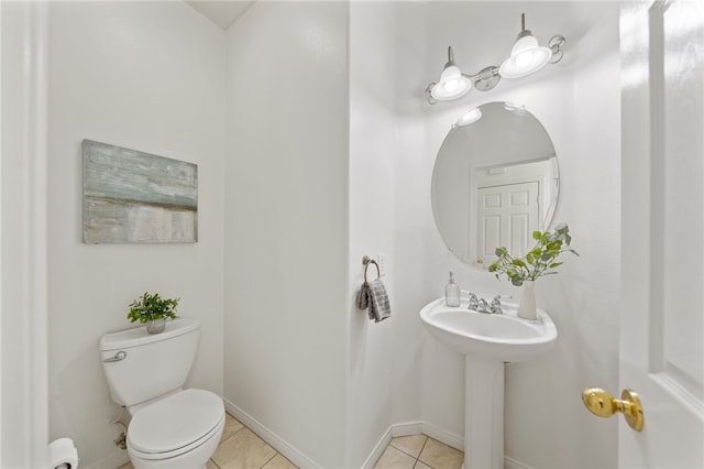 half bathroom featuring toilet, tile patterned flooring, and baseboards