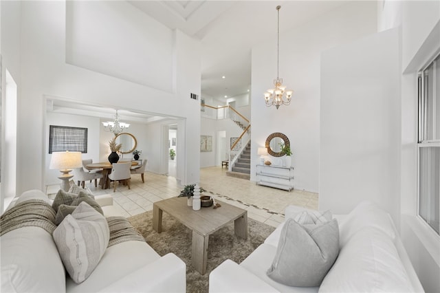 tiled living room featuring a towering ceiling, an inviting chandelier, and stairs