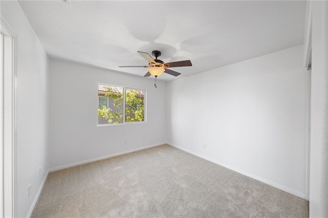 empty room with carpet floors, ceiling fan, and baseboards