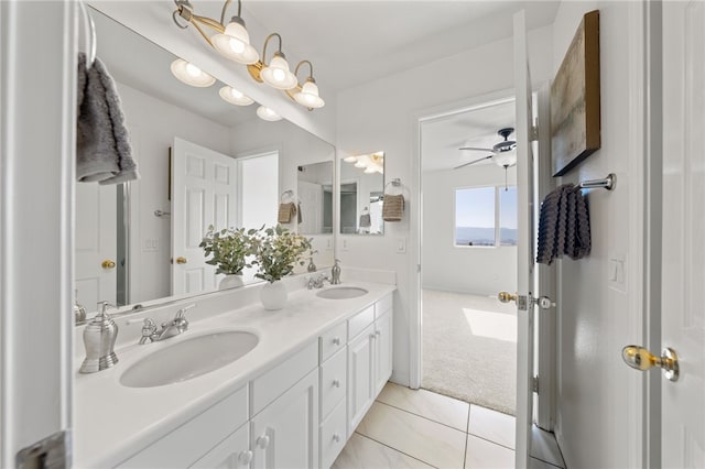 full bath with a ceiling fan, tile patterned flooring, a sink, and double vanity